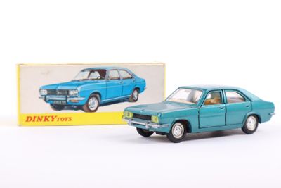 an image of a blue toy car sitting next to a box of dinky toys