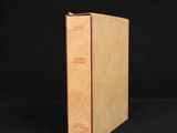 a brown book sitting on top of a black surface