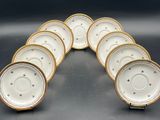 a set of six white and gold china plates