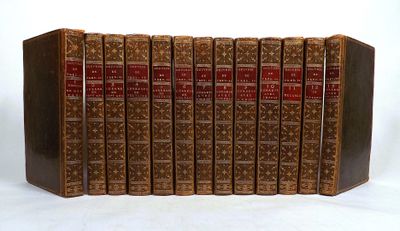 the books are lined up in a row on a white surface
