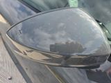 reflection of a person in a car mirror on the side of the road