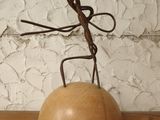 a metal sculpture of a man holding a ball on a table