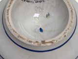 a white bowl with a blue stripe around the rim