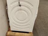 a washing machine that is sitting on a pallet in a warehouse