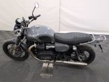 a picture of a motorcycle that is parked on a checkered floor