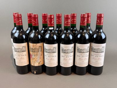 six bottles of wine are lined up in a row on a table