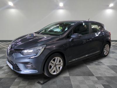 a grey car is parked on a checkered floor in a garage