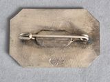 a small metal object with a metal handle on it