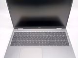 an open laptop computer sitting on top of a white surface