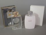 a bottle of perfume next to a box on a table