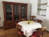 a dining room table with a white table cloth on it