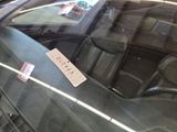 a sticker on the windshield of a car with a price tag attached to it