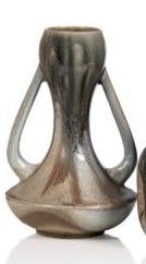 two vases sitting next to each other on a white surface
