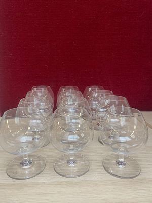 several empty wine glasses are lined up on a wooden table