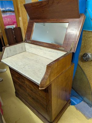 a wooden chest with a mirror on top of it