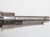 a silver revolver with a silver handle on a white surface