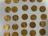 a lot of gold coins on a white surface
