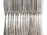 a lot of forks and spoons stacked on top of each other