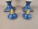two blue vases with gold decorations on them