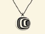 black and white striped pendant on a chain on a white background
