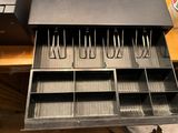 a metal drawer that has a bunch of utensils in it