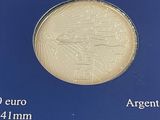 the coin is in a blue box on a white surface