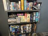 a book shelf that has a lot of games on it