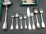 a lot of silver spoons and forks on a table