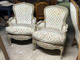 two chairs sitting next to each other in a room