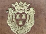 a brown book with a gold emblem on it