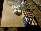 a table with cups and cups on it in the dark
