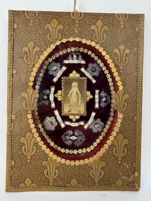 an image of a gold and red plaque with a picture of a buddha