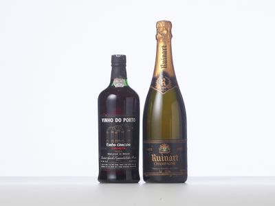 two bottles of wine sitting next to each other on a table