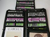 a lot of different colored pens in a case on a table