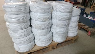 several stacks of white plates stacked on a pallet in a warehouse