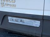 a close up of a white truck with a sticker on it ' s bumper