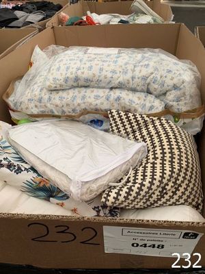 a cardboard box full of pillows and pillows on the floor