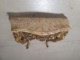 a marble shelf on the wall next to a mirror