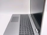 a silver laptop computer sitting on top of a white table