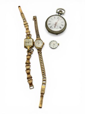 an image of a couple of watches sitting next to each other on a white surface