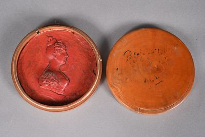an image of a red and brown box with a bust of a woman