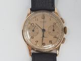 an image of a gold wrist watch with a black leather strap