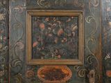 a wooden cabinet with a floral design painted on it