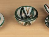 three different types of ceramic objects on a table