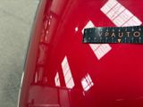 a close up of a sticker on the hood of a red car