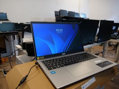 a laptop computer sitting on top of a wooden table