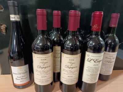 plusieurs bouteilles de vin rouge sont alignées sur une table