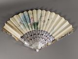 a fan that is hanging on the wall next to a wall