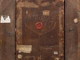 painting of a woman ' s face on a wooden frame with stickers