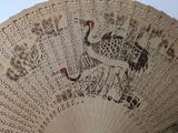 a close up of a fan with a bird on it